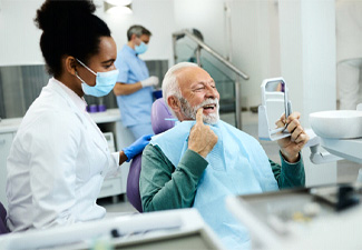 man at dentist with dentures in Leawood