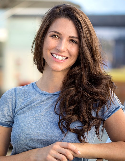 woman smiling in blue t-shirt