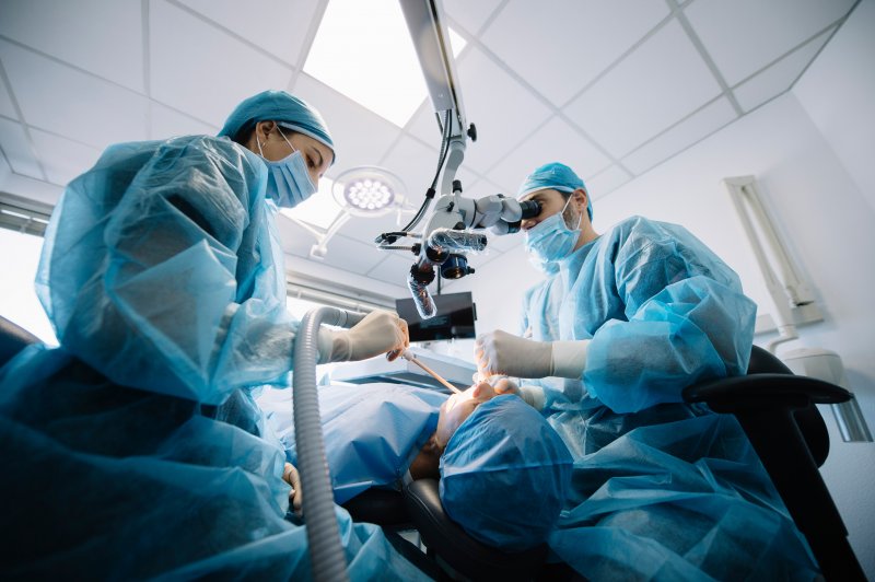 Dentists performing a dental implant surgery