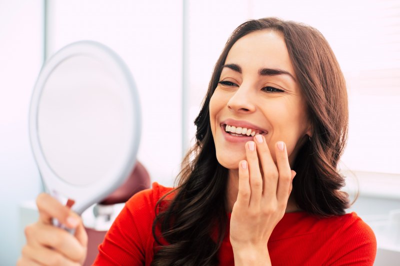 Patient looking at their face in a mirror after Botox treatment